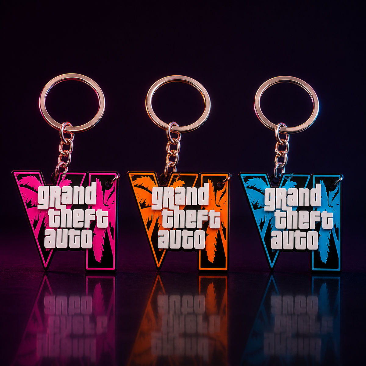 Drei GTA-inspirierte VI-Schlüsselanhänger in Pink, Orange und Blau